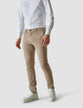 Male model wearing sand/beige pants seen from the front