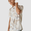 Model from the front wearing a Classic Short-Sleeved Shirt Stone a light shirt with a slolid marbled pattern