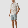 Model in full body wearing a Classic Short-Sleeved Shirt Stone a light shirt with a slolid marbled pattern