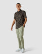 Model in full body wearing a Classic Short-Sleeved Summer nights a black shirt with a wide floral pattern