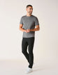 Model in full body wearing dark grey t-shirt with black pants and white sneakers