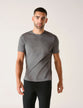 Model wearing dark grey t-shirt seen from the front