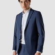 Model from the front wearing a Marine Blue Blazer with a white shirt and matching suit pants