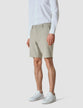 Model seen from the front wearing essential Shorts Duo Check green shorts with a white shirt
