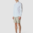 Model in full body wearing Essential Shorts Duo Check green shorts with a white shirt