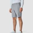 Model seen from the front wearing Essential Shorts Light blue with a white shirt tucked in