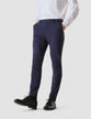 Model from the front wearing a pair of Essential Suit Pants in Bristol Blue with a compact checked pattern