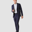 Model in full body wearing a pair of Essential Suit Pants in Bristol Blue with a compact checked pattern