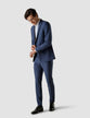 Model in full body wearing a pair of Essential Suit Pants Marine Blue 