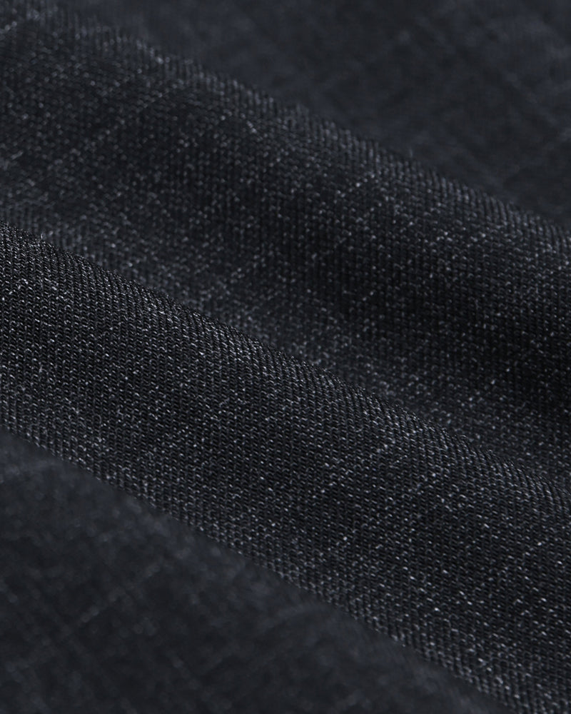 Close-up of a dark charcoal fabric with a subtle checkered weave.
