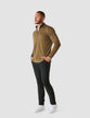 Model in full body wearing a Dark Olive half zip in fitted knit with a white shirt underneath