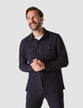 Model from the front wearing a midnight/ dark blue overshirt buttoned up