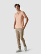 Model in full body weraing a Piquet Polo Shirt Coral
