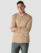 Model seen from the front wearing sand grain half zip in fine knit with a white t-shirt underneath