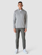Model in full body wearing grey stone half zip in fine knit with a white t-shirt underneath