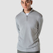 Model seen from the front wearing grey stone half zip in fine knit with a white t-shirt underneath