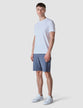 Model in full body wearing Classic Shorts blue mirage shorts with a white t-shirt