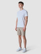 Model in full body wearing Classic Shorts Sand/Beige with a white t-shirt tucked in