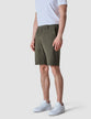 Model seen from the front wearing Classic Shorts urban green shorts with a white t-shirt