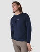 Model from the front wearing a navy blue long sleeved t-shirt 