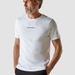 Model wearing white t-shirt seen from the front the t-shirt has the company logo across the chest