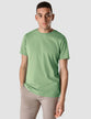 Model wearing moss green t-shirt seen from the front