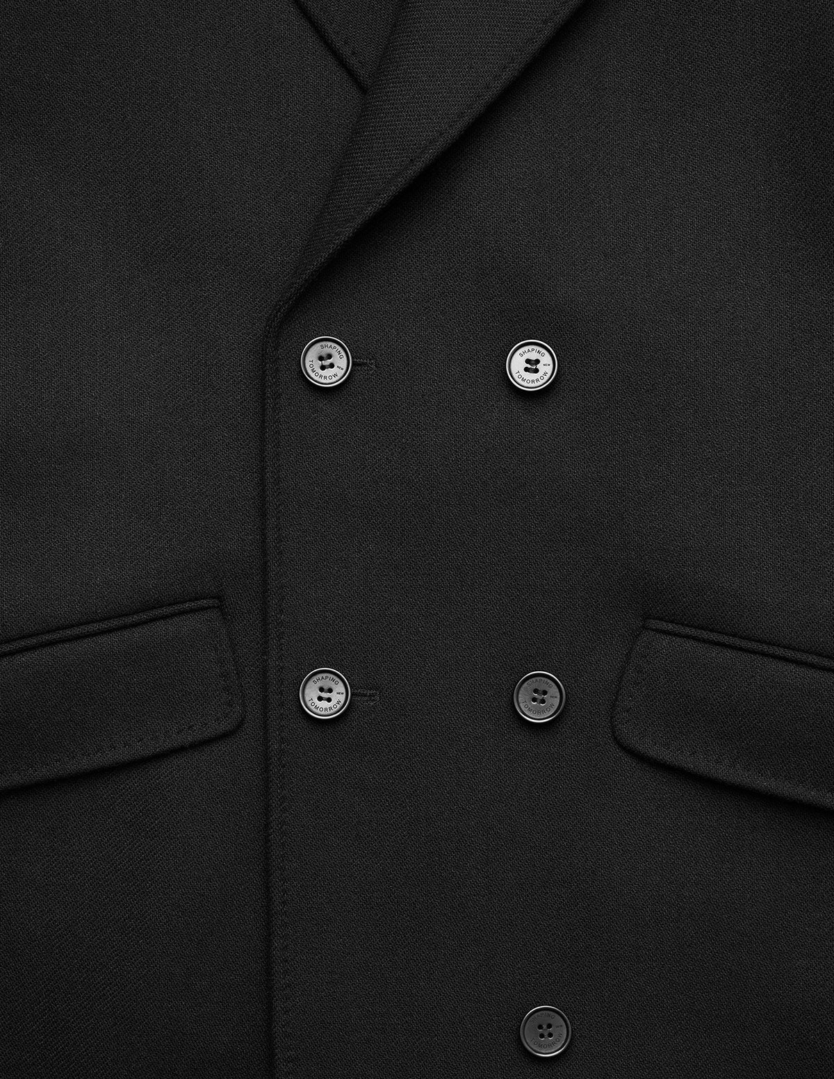 Women’s Wool Coat Black in a Scandinavian design with a double-breasted front, four visible buttons, and two flap pockets.