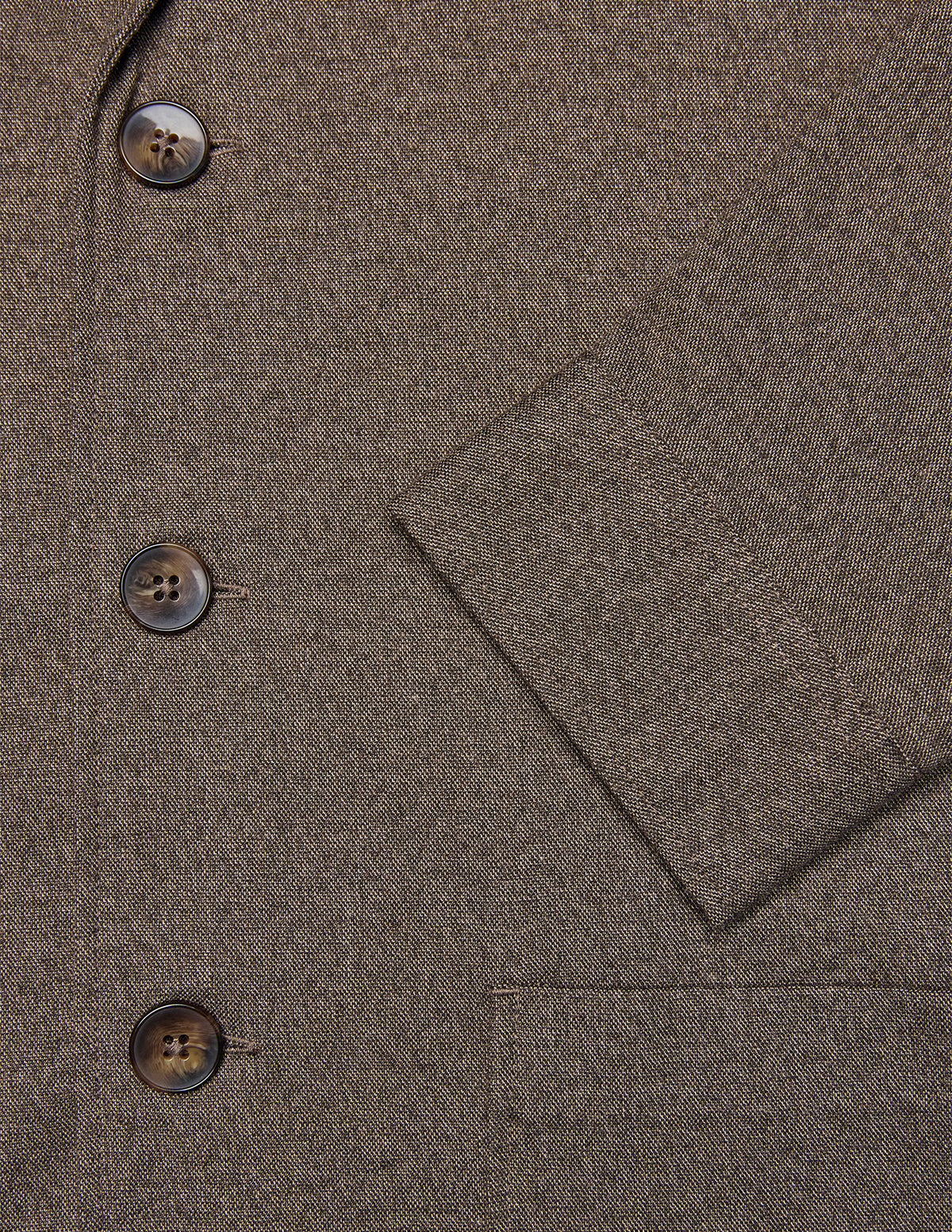 Close-up of the Atelier Overshirt Dark Beige, a heavyweight twill overshirt in dark beige with three brown buttons and a cuffed sleeve in a minimalist Scandinavian design.