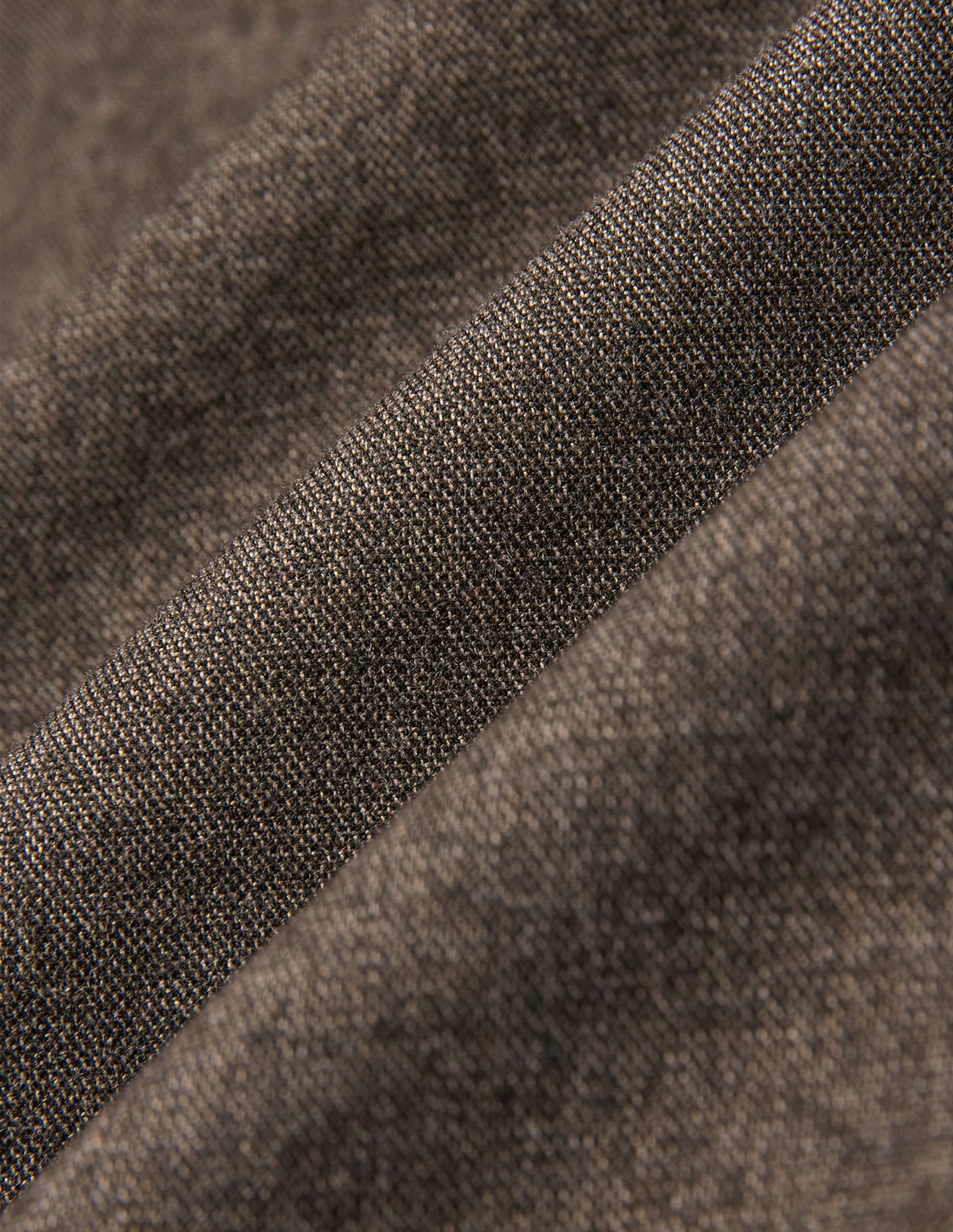 Close-up of the Atelier Overshirt Dark Beige in heavyweight twill fabric, showing a visible woven texture and diagonal folds.