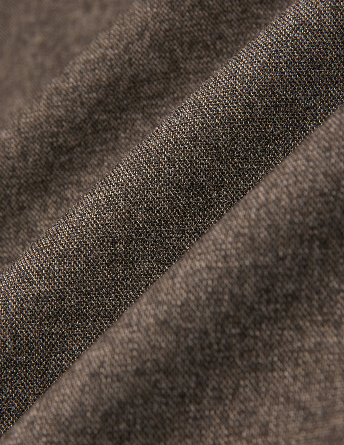 Close-up of the Atelier Overshirt Dark Beige in heavyweight twill fabric, showing a visible woven texture and diagonal folds.