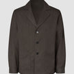 Atelier Overshirt in dark brown, a button-front blazer in heavyweight textured fabric featuring a notched lapel and two front patch pockets.
