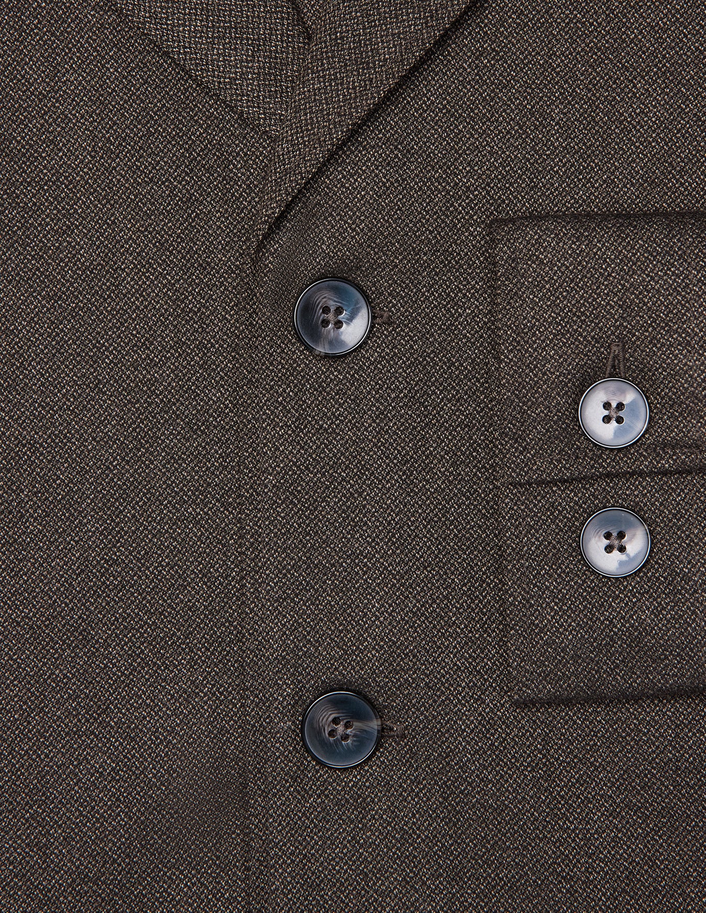Close-up of the dark brown Atelier Overshirt in a heavyweight textured fabric, featuring two front buttons and two matching buttons on the sleeve cuff.