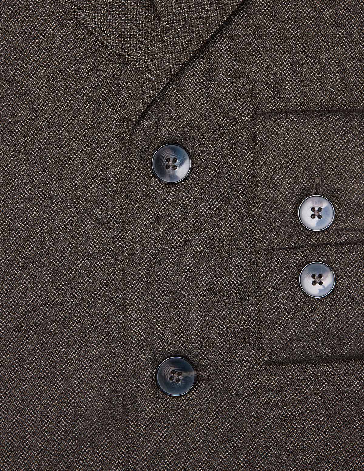 Close-up of the dark brown Atelier Overshirt in a heavyweight textured fabric, featuring two front buttons and two matching buttons on the sleeve cuff.