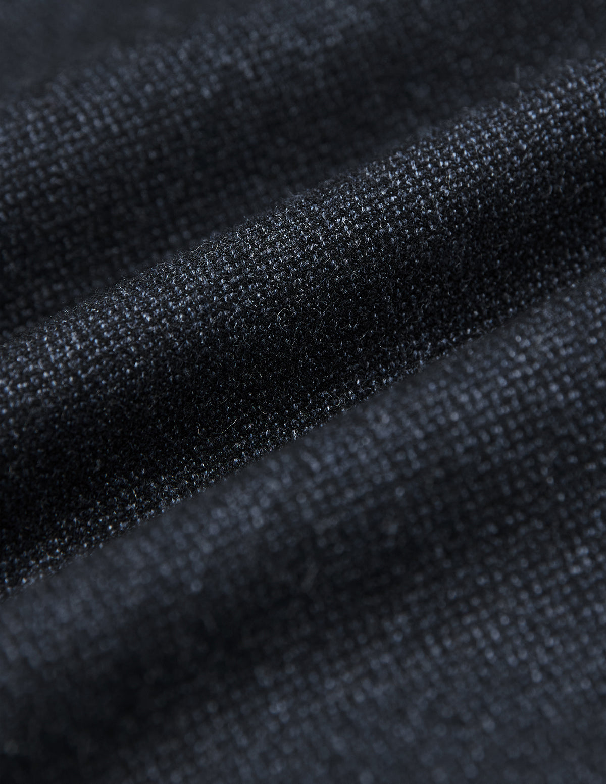 Close-up of the Atelier Overshirt Dark Navy, featuring a heavyweight, textured woven surface in a dark navy hue with soft folds.