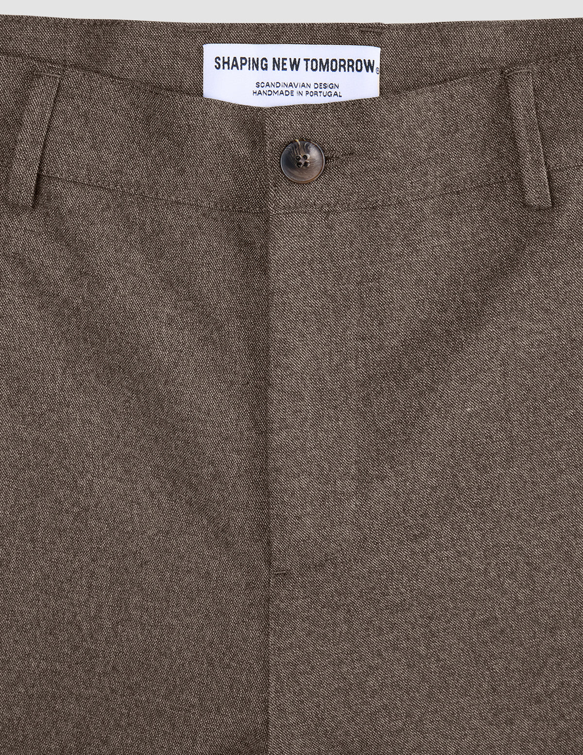 Close-up of the button fly and waistband on Atelier Pants Relaxed Dark Beige in heavyweight broken twill, featuring an internal brand label and minimalist Scandinavian design.