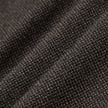 Close-up of folded dark brown Atelier Pants Relaxed Dark Brown fabric with a textured, heavyweight broken twill pattern.