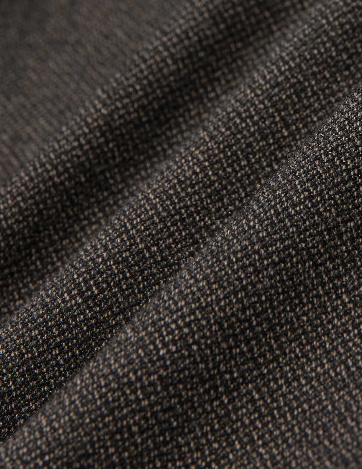 Close-up of folded dark brown Atelier Pants Relaxed Dark Brown fabric with a textured, heavyweight broken twill pattern.
