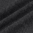 Close-up of dark grey Atelier Pants Relaxed in heavyweight broken twill fabric, featuring prominent diagonal folds and a textured finish.