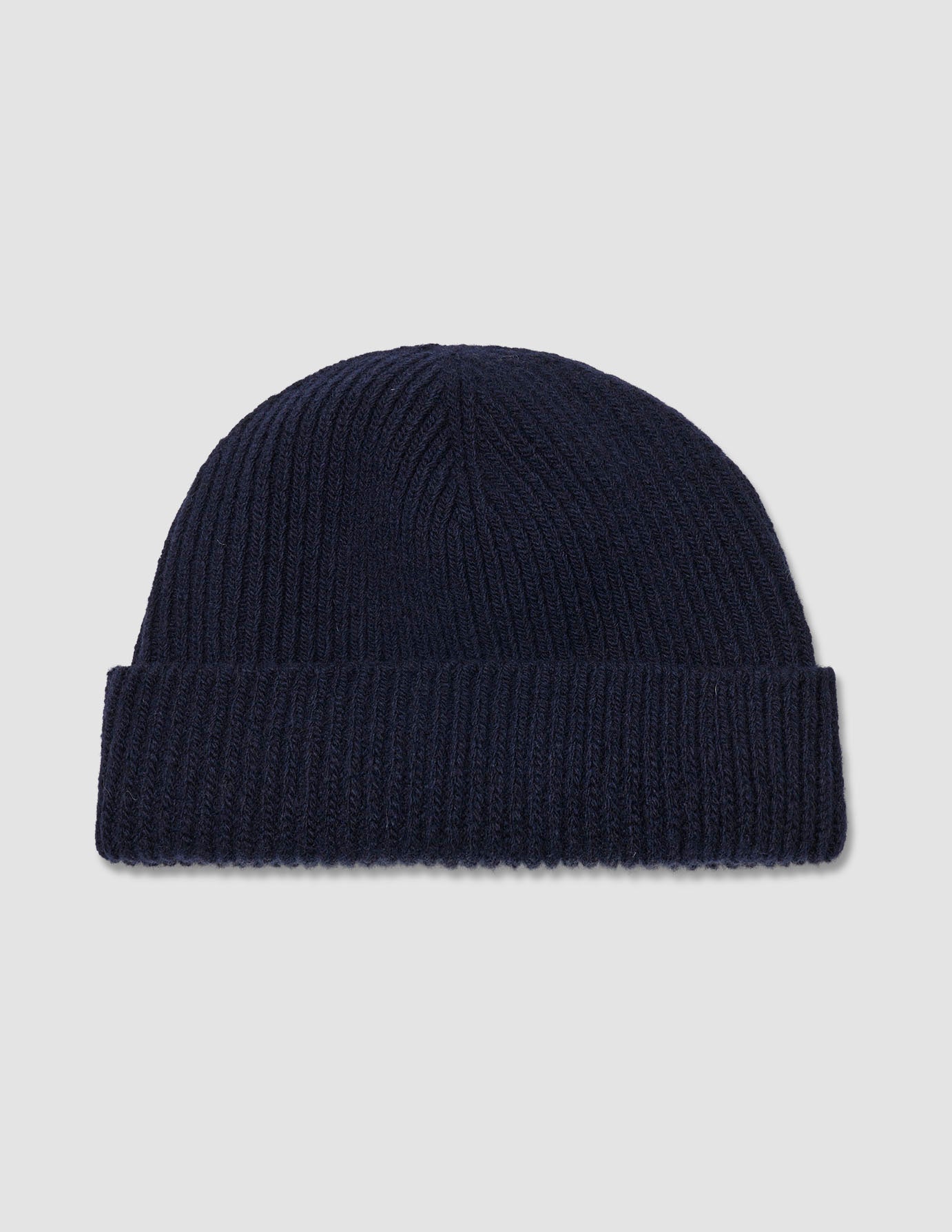 Wool Beanie Navy navy blue merino wool ribbed-knit beanie with a folded cuff.