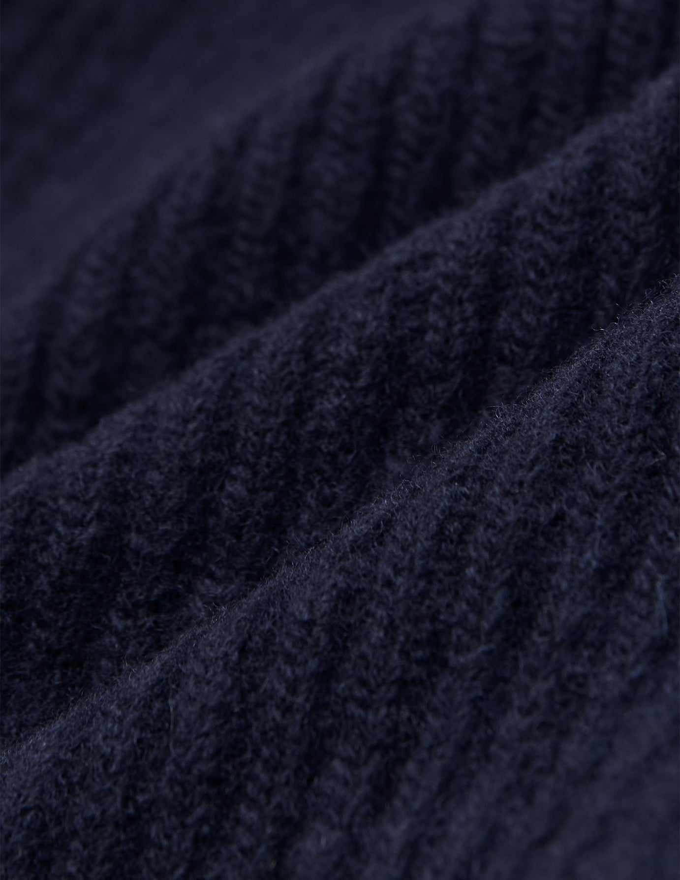 Close-up of a navy blue rib knit Wool Beanie Navy.