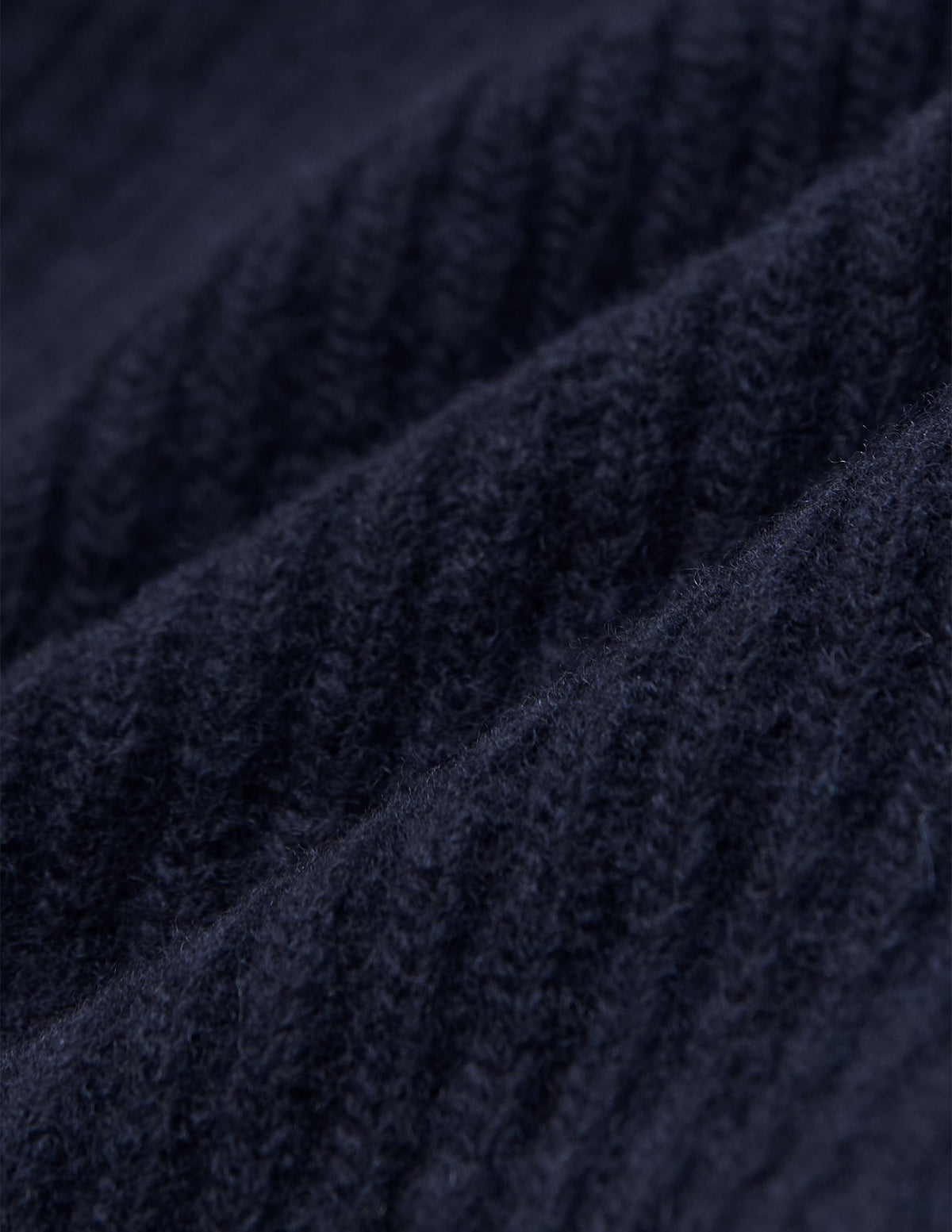 Close-up of a navy blue rib knit Wool Beanie Navy.