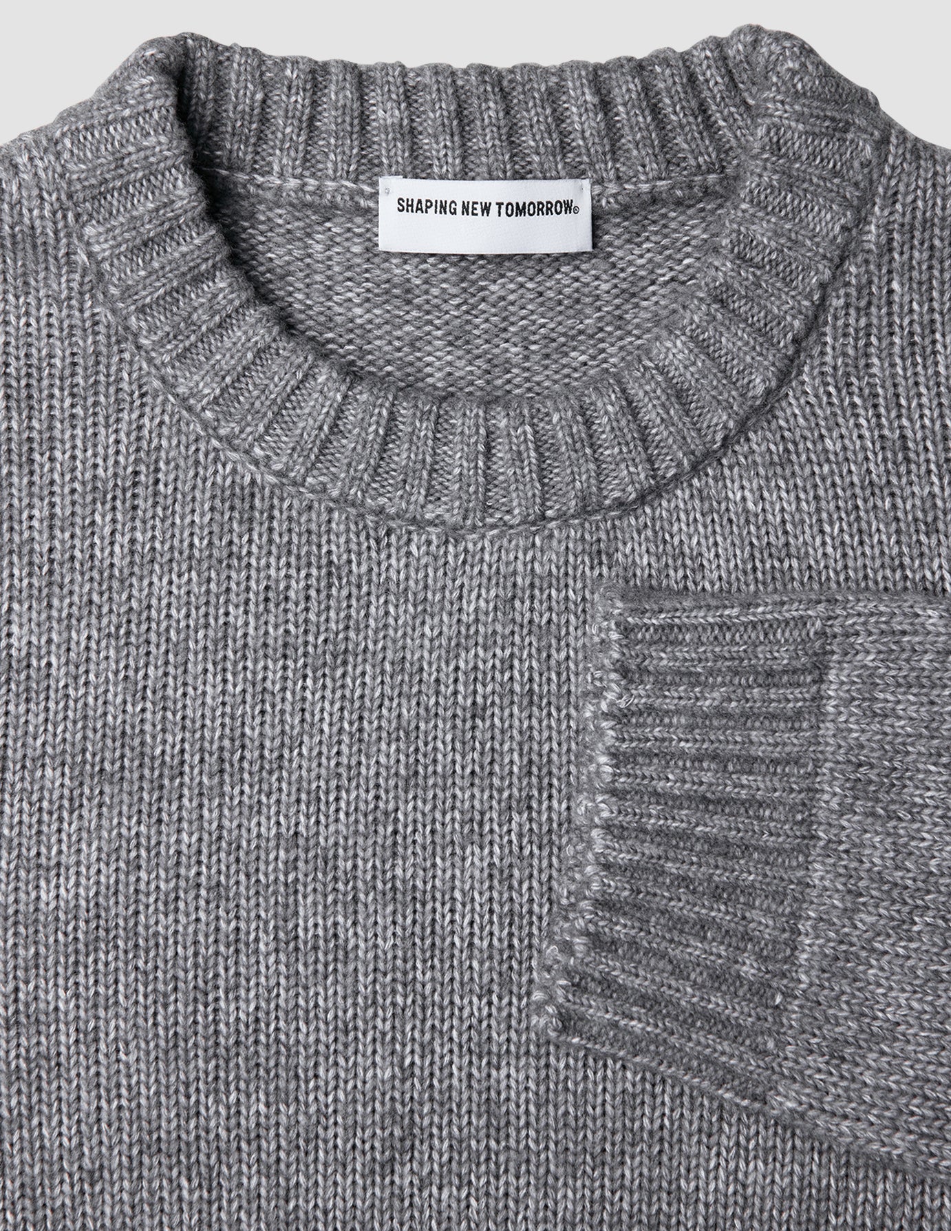 Chunky Soft Wool Knit Crewneck Glacier Grey sweater in a grey marled Scandinavian design with a chunky knit, ribbed collar, and sleeve cuffs.