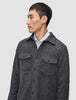 A man wearing a Double Layer Wool Overshirt Regular Dark Grey in a Scandinavian design over a white collared shirt.
