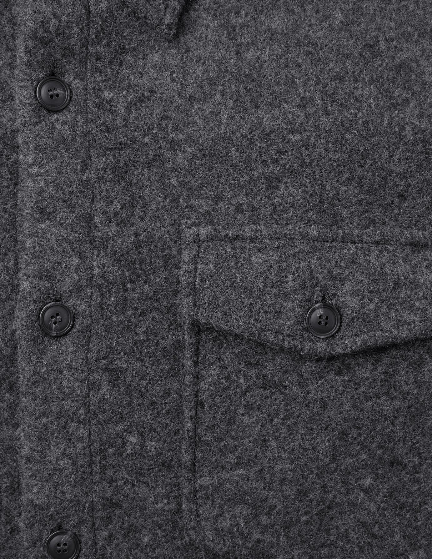 Close-up of a Double Layer Wool Overshirt Regular Dark Grey featuring a buttoned placket and a single chest pocket with a matching button.
