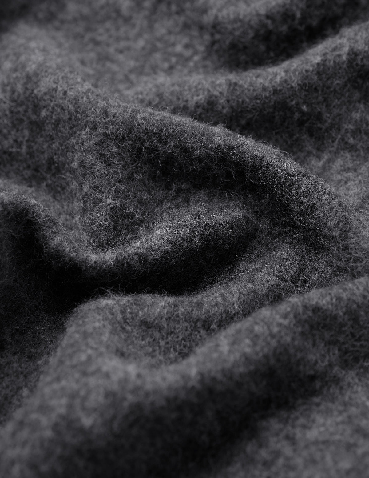 Close-up of the Double Layer Wool Overshirt Regular Dark Grey, showing the thick, dark grey felted wool blend fabric with folds.