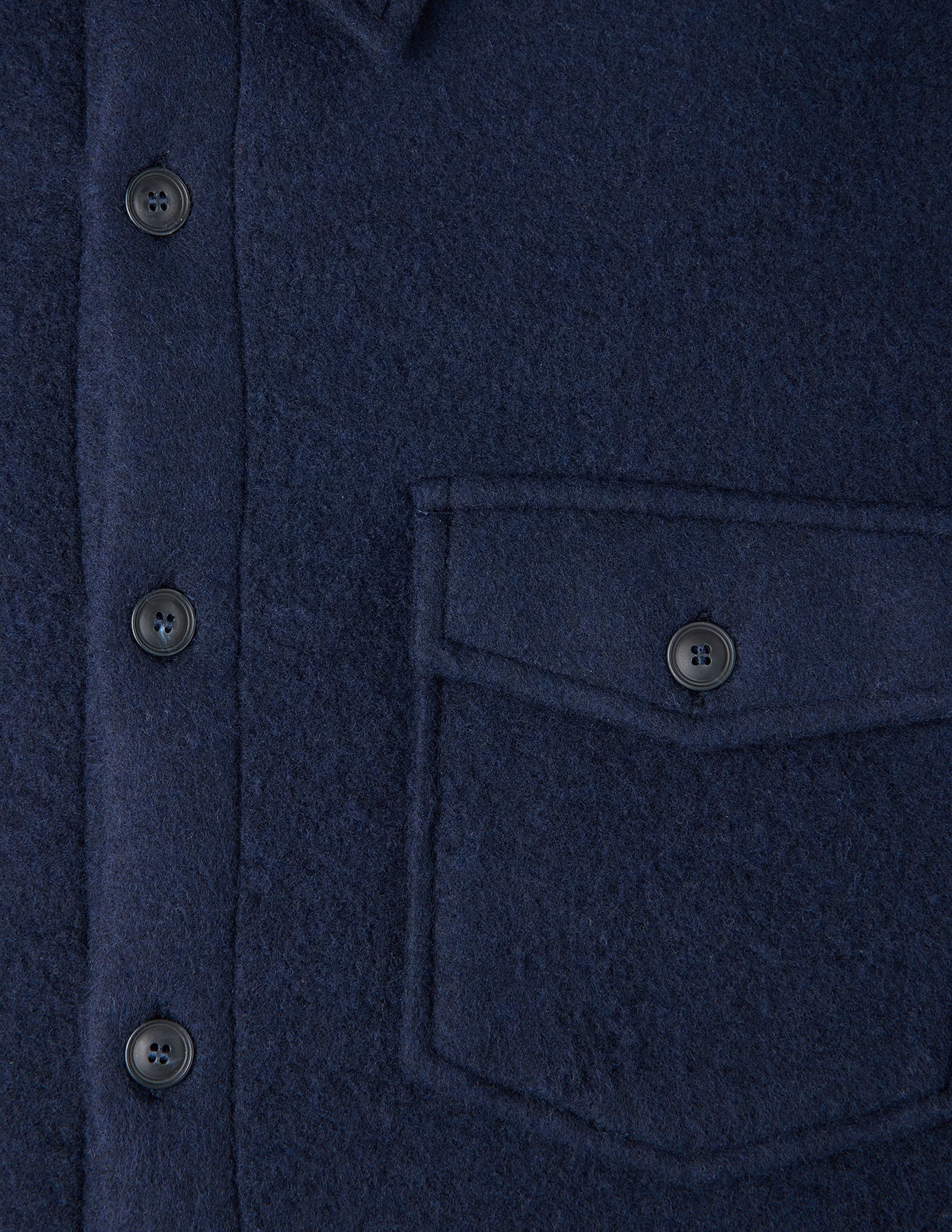 Close-up of a Double Layer Wool Overshirt Regular Dark Navy in a wool blend, featuring a center button placket and a single chest pocket with a buttoned flap.