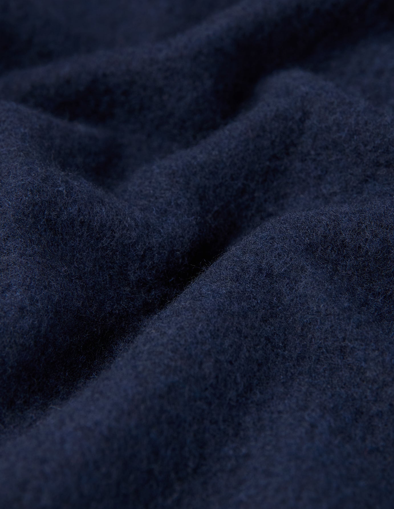 Close-up of a Double Layer Wool Overshirt Regular Dark Navy in navy blue with deep fabric folds.