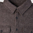 Close-up of a Double Layer Wool Overshirt Saddle Brown, featuring a brown wool design with a pointed collar, button-down front, and two buttoned chest pockets.