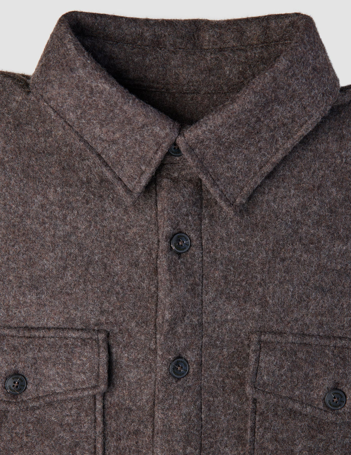 Close-up of a Double Layer Wool Overshirt Saddle Brown, featuring a brown wool design with a pointed collar, button-down front, and two buttoned chest pockets.