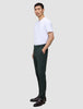 A person in a white t-shirt and dark green Ease Pants Regular Northern Pine stands in profile with one hand in their pocket.